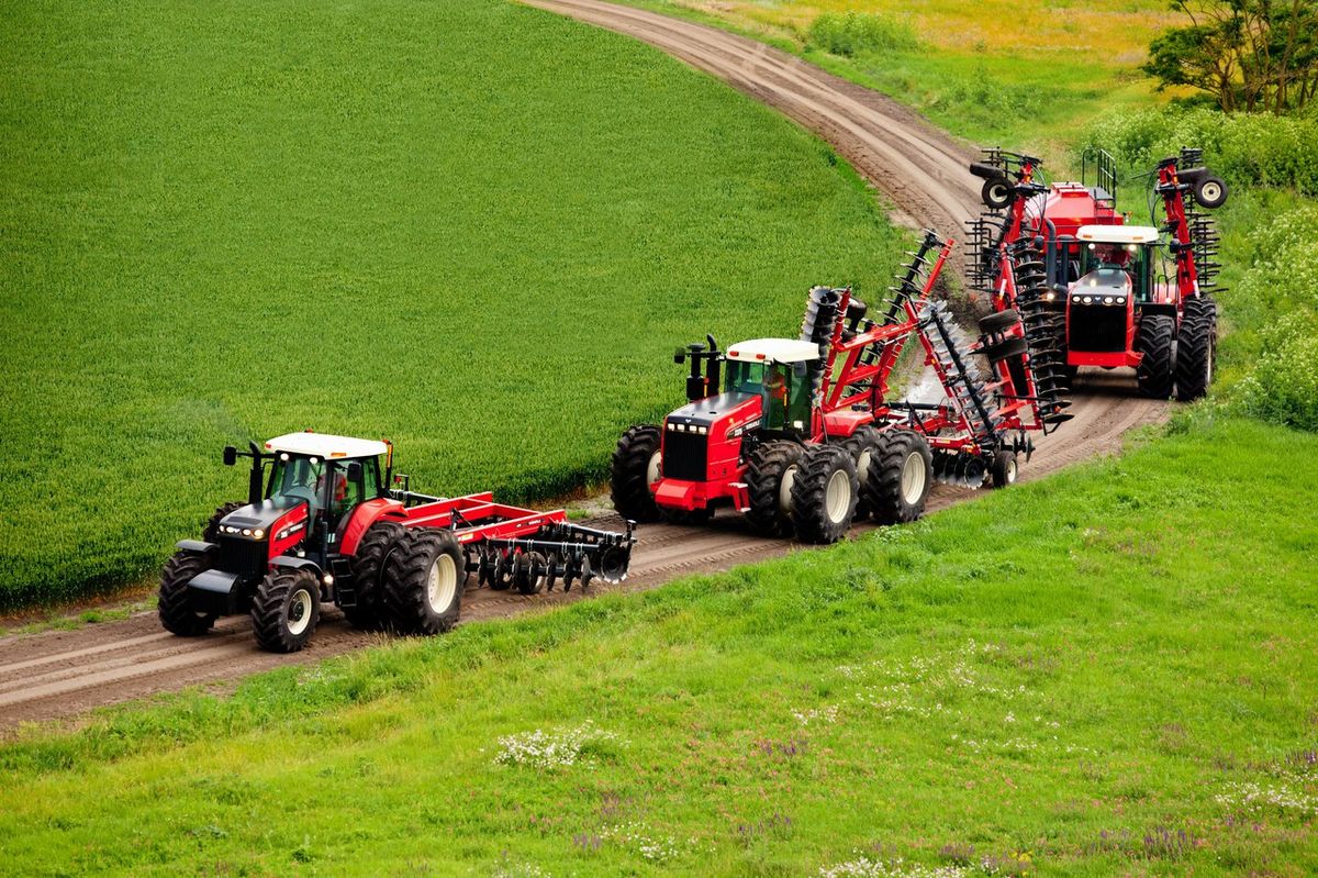 Tractors and agricultural machinery working a field